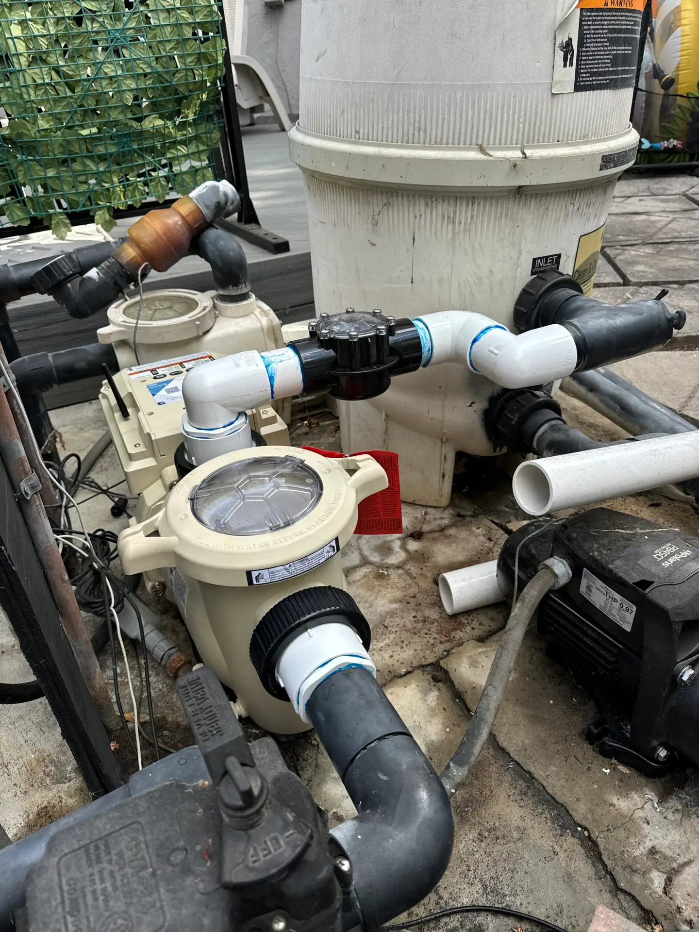 Pool pump, filter and plumbing on a residential pool equipment pad