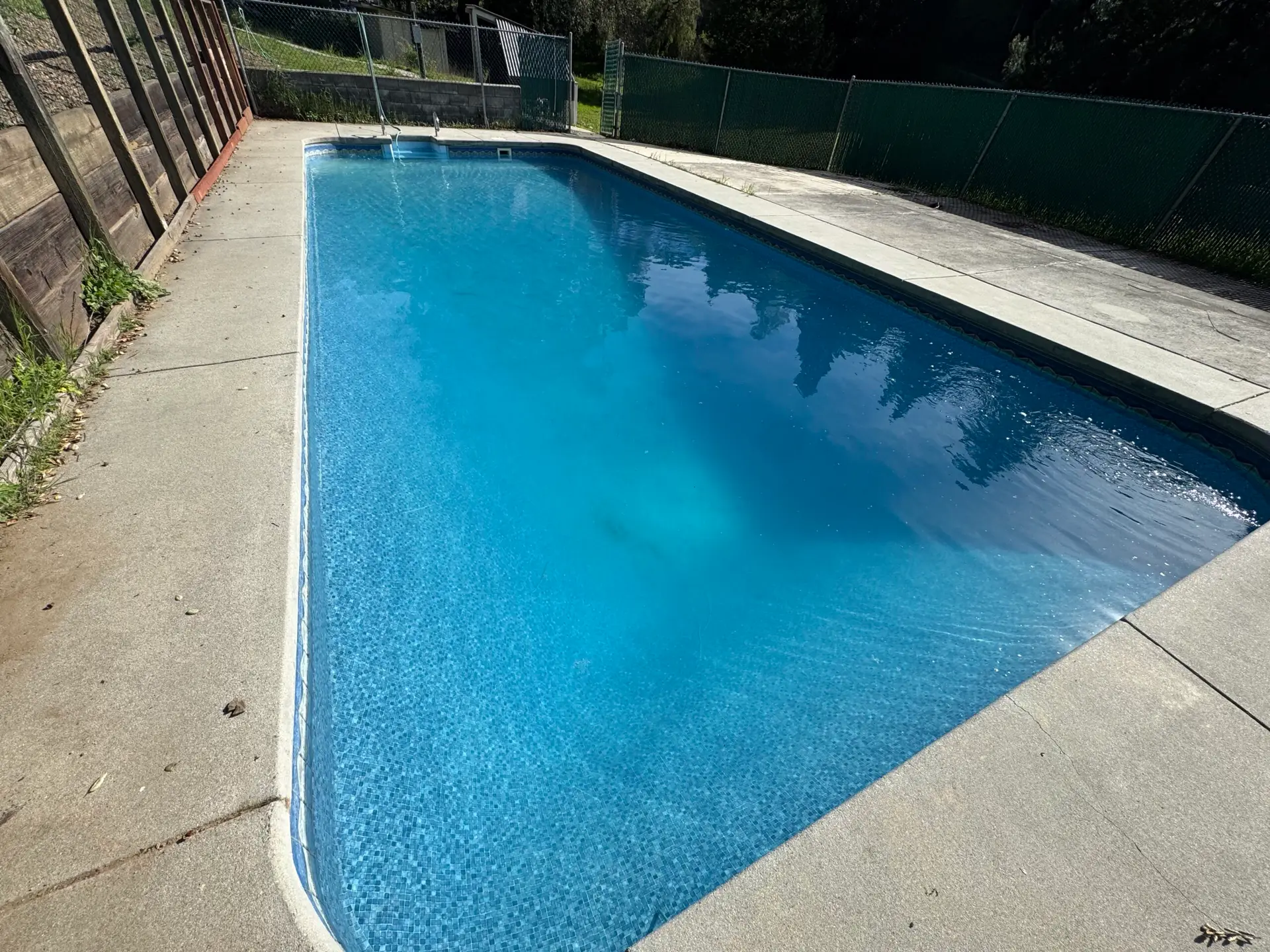 Rectangular pool with clear blue water and a light interior finish