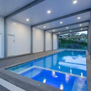 Pool lit by LED lights under a covered patio
