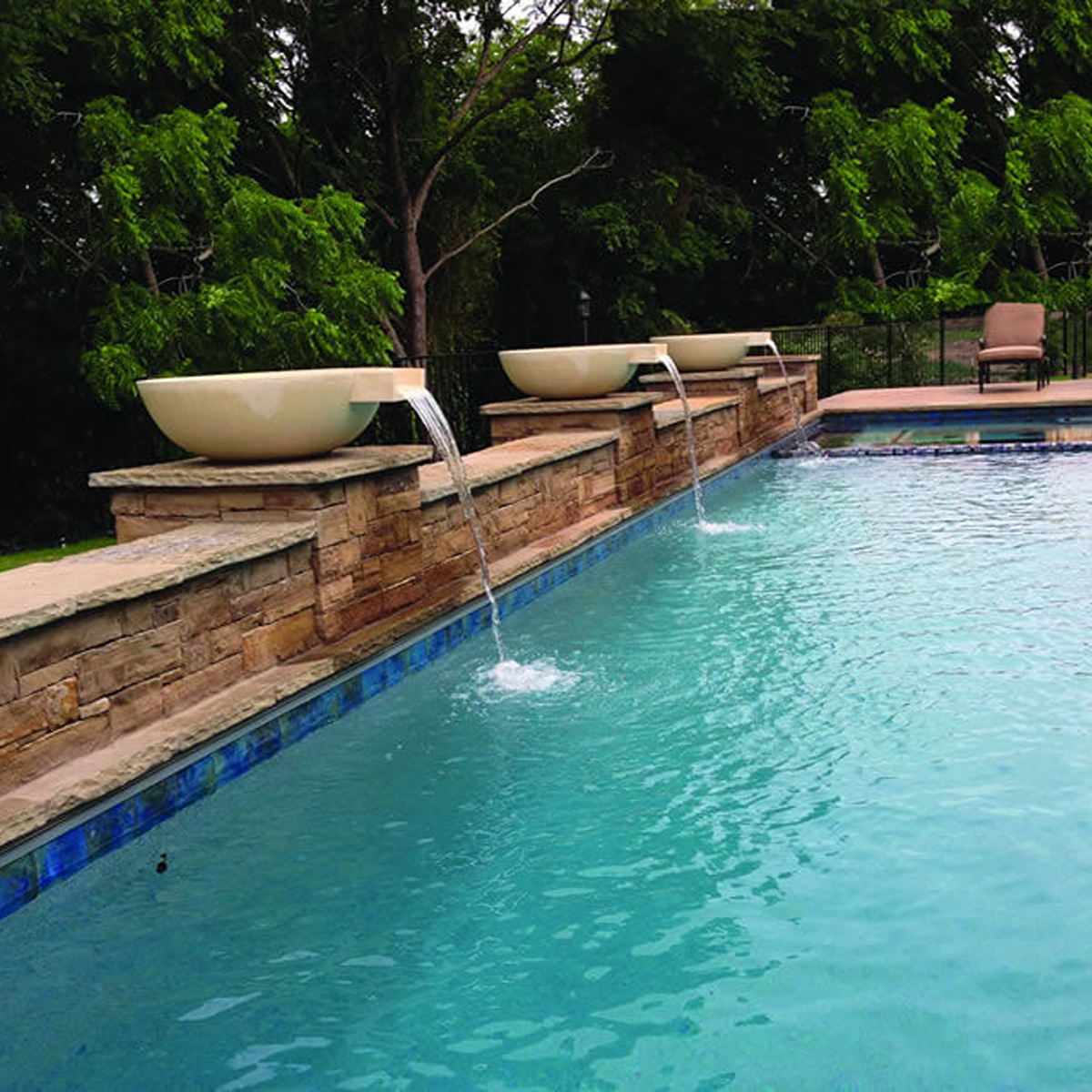 Pool scuppers water feature added during a pool remodel in North Texas
